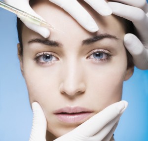 young woman gets a botox injection into the skin